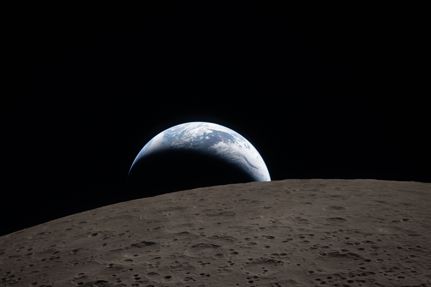 Photo from Artemis II mission showing the lunar surface and Earth in the background
